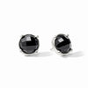 A pair of silver stud earrings featuring round black faceted gemstones in a prong setting, shown on a clean white background.