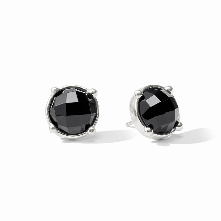 A pair of silver stud earrings featuring round black faceted gemstones in a prong setting, shown on a clean white background.