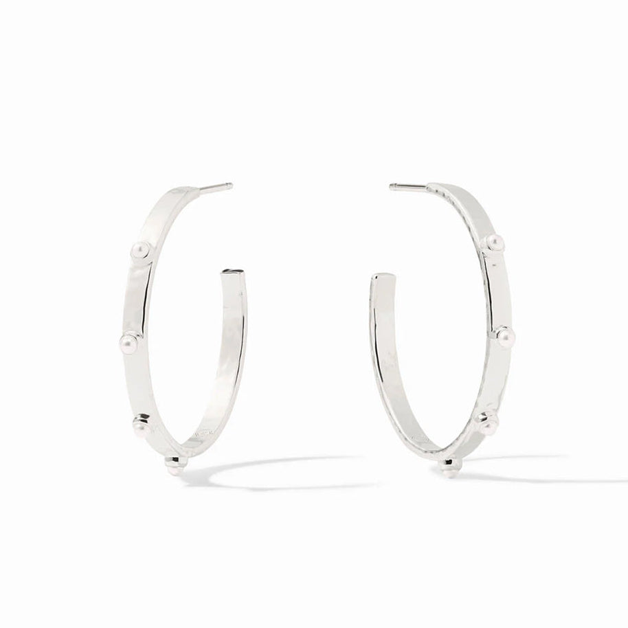 A pair of polished silver hoop earrings with small, evenly spaced round pearl-like beads set along the front, displayed on a clean white background.