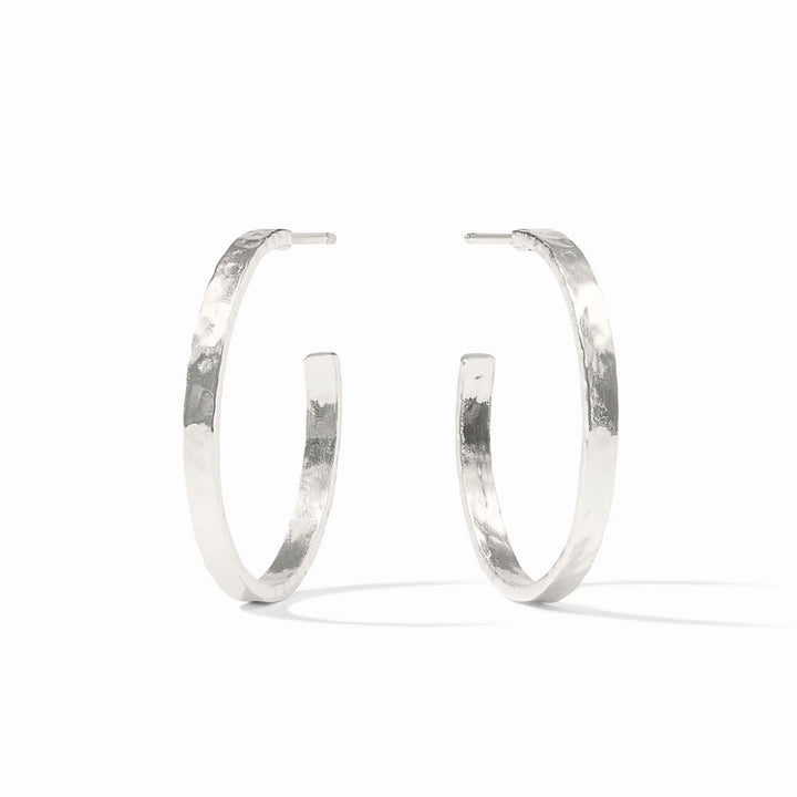 A pair of textured silver hoop earrings with a hammered finish, displayed on a clean white background.