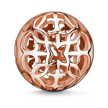 Rose gold Karma Bead Arabesque charm; intricate, spherical design.
