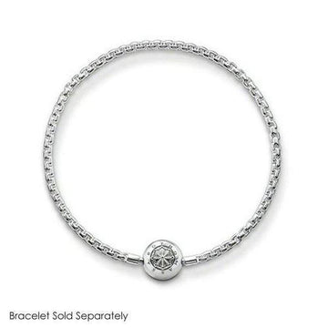 Silver charm featuring an intricate circular design, shown on a delicate chain bracelet (bracelet sold separately).
