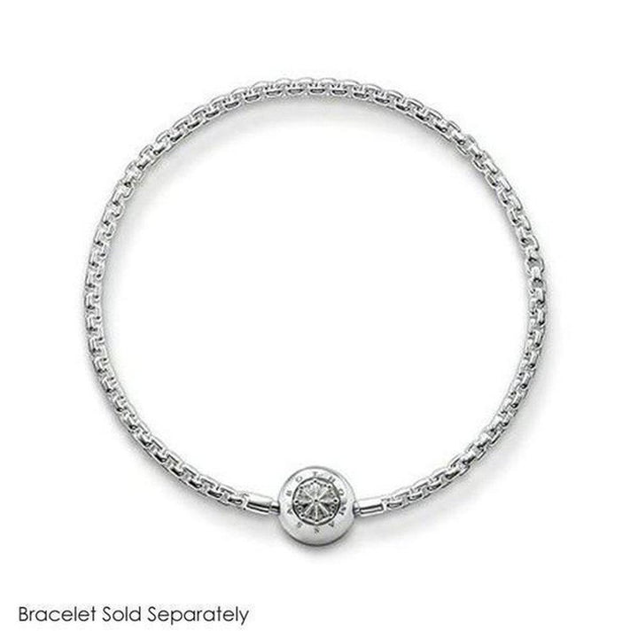 Silver lotus charm with detailed design, on a delicate chain bracelet.
