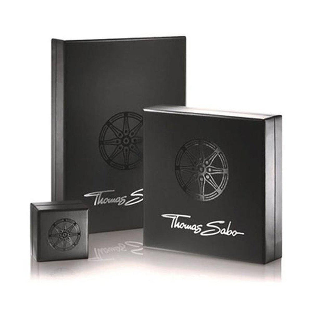 Elegant black jewelry boxes showcasing a karma bracelet.
