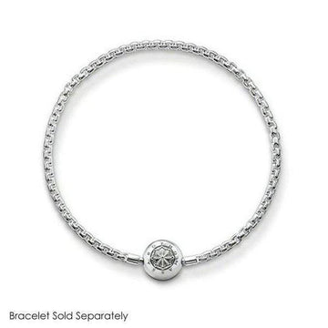 Silver charm featuring an eye design, attached to a delicate chain bracelet (sold separately).
