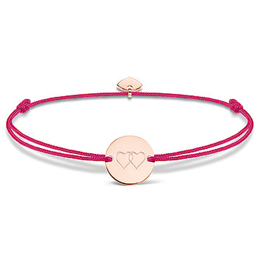 Rose gold heart medallion bracelet on a pink cord.
