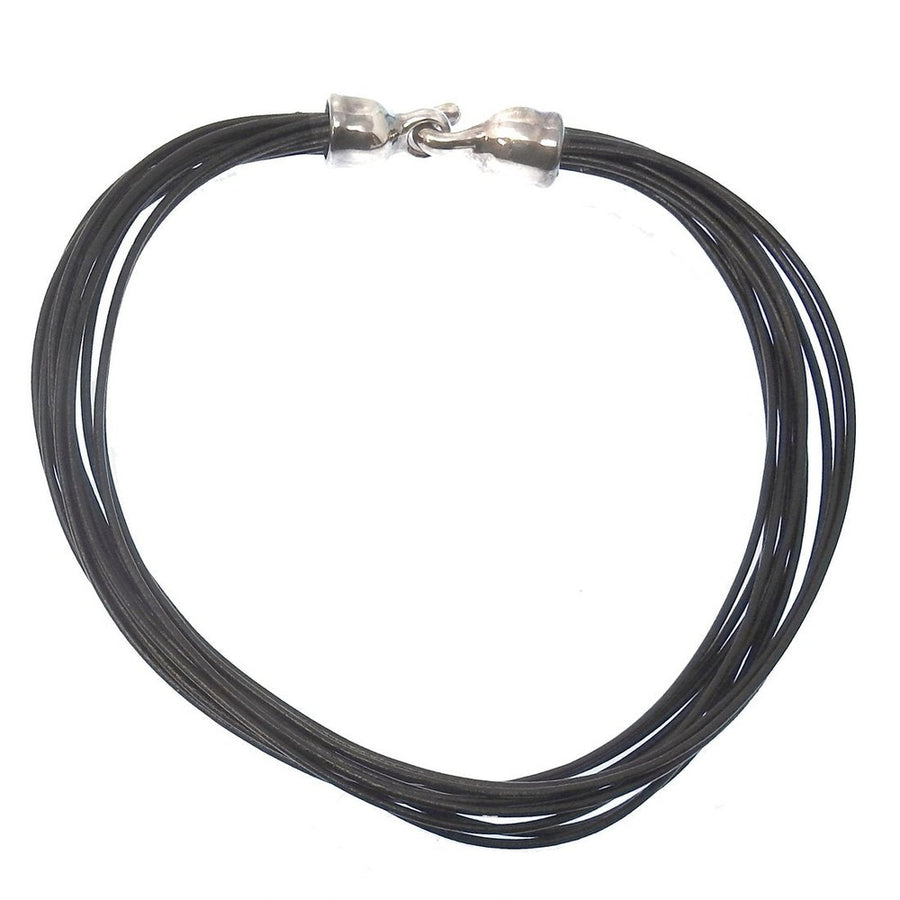 Multi-strand black leather necklace with silver clasp.
