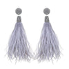 Light gray feather earrings with crystal accents for a glamorous look.
