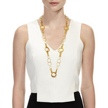 Gold long necklace featuring interconnected circular links on a model.
