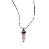 Love Heals Nico Fluorite Pendant: Purple, layered fluorite point on a dark cord necklace with gold accents.
