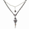 Love Heals Valeria necklace: layered chain, pearl accents, heart charm, antique silver finish.
