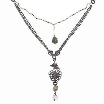Love Heals Valeria necklace: layered chain, pearl accents, heart charm, antique silver finish.
