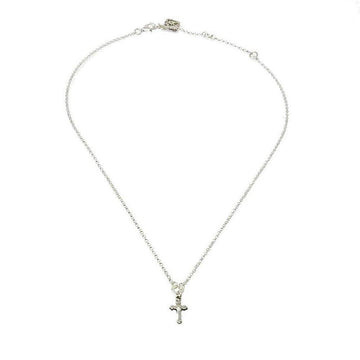 Dainty silver cross pendant necklace on a delicate chain.
