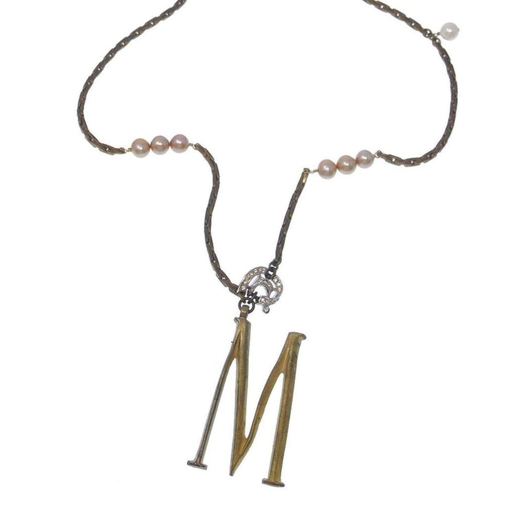 Lulu Frost Plaza Letter M Necklace: gold initial M pendant with bronze chain and blush pearls.
