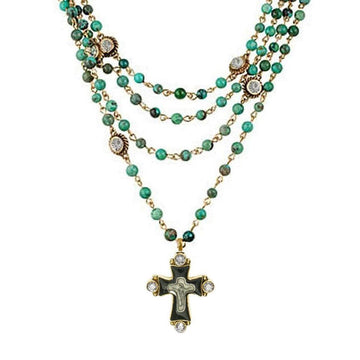 Multi-strand turquoise bead necklace with gold accents and a detailed cross pendant.
