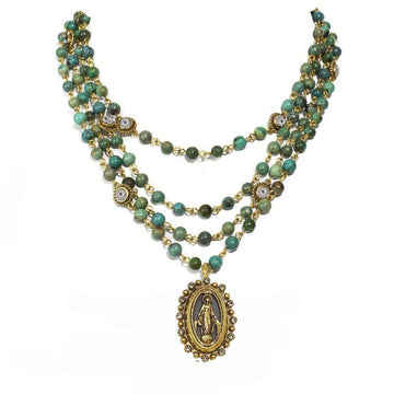 Three-strand turquoise bead necklace with gold accents and Virgin Mary pendant.
