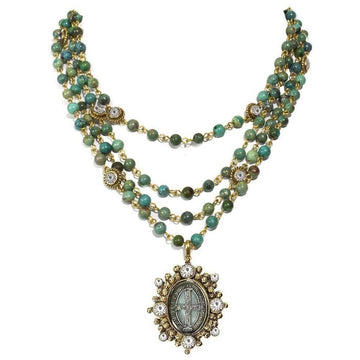 Lux Turquoise Magdalena Asst Medals necklace: Three-strand turquoise & gold beaded necklace with a detailed antique-style pendant.
