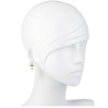 Gold cross earrings on a mannequin.
