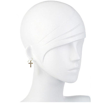 Gold cross earrings on a mannequin, showcasing detailed design.
