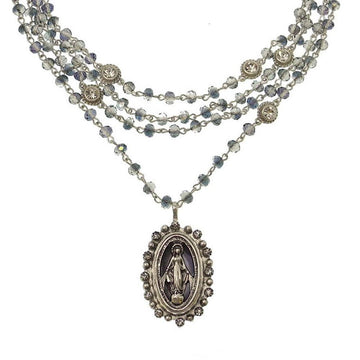Multi-strand necklace featuring a silver Virgin Mary pendant, accented with blue crystals.
