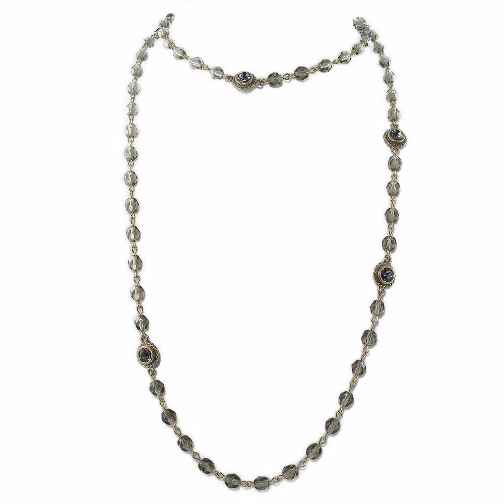 Gray glass bead necklace with gold accents.
