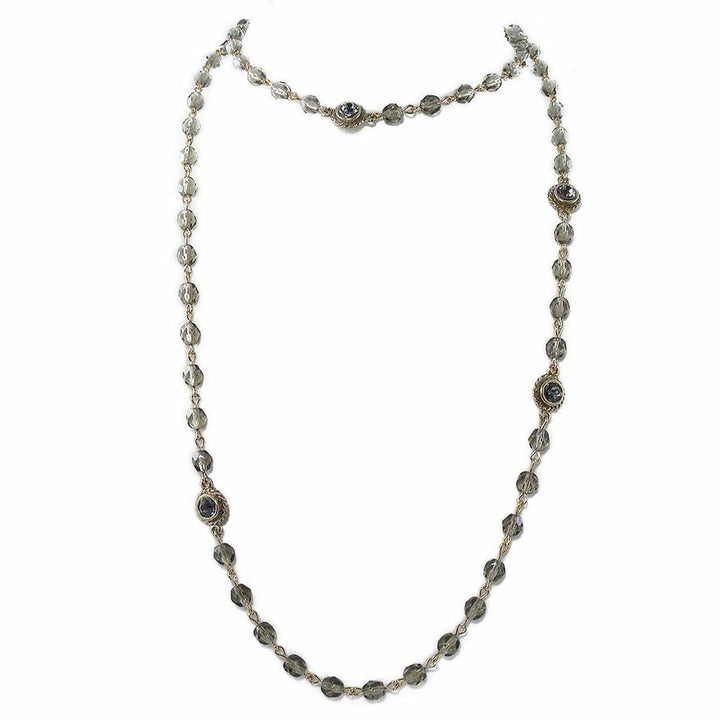 Gray glass bead necklace with gold accents.
