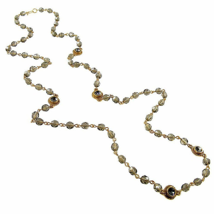 Smoky quartz and gold beaded necklace with accents.
