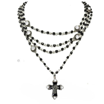 Layered black bead necklace with a silver cross pendant, accented by clear crystals.

