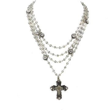 Layered crystal bead necklace with ornate cross pendant.
