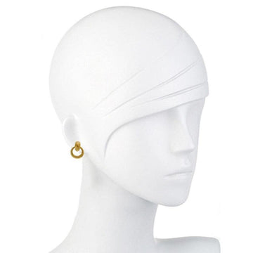 Gold doorknocker-style earrings on a mannequin, showcasing minimalist design.
