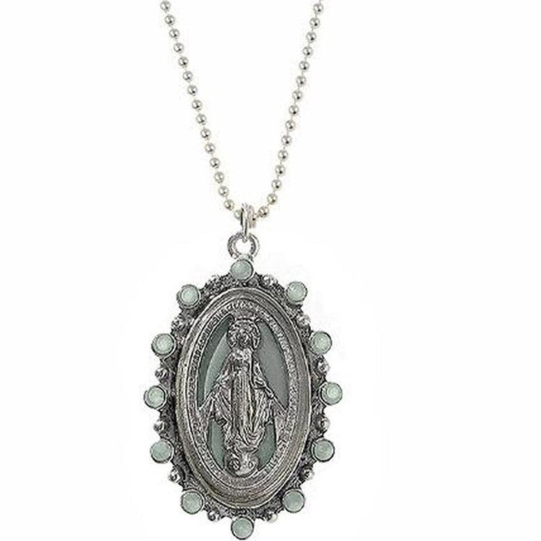 Oval silver pendant necklace featuring a pale green Virgin Mary image, accented with small stones.
