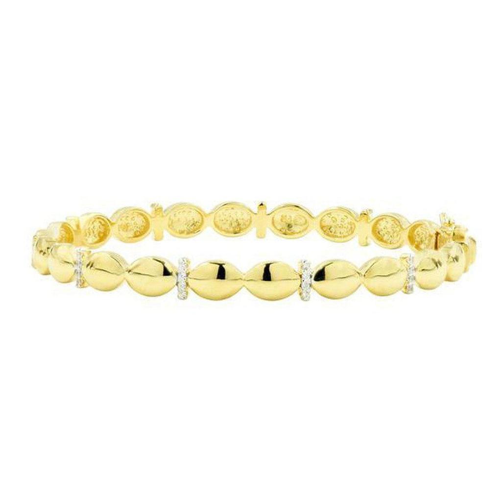 Gold bangle bracelet with diamond accents.
