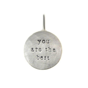 Silver pendant inscribed "You are the best."
