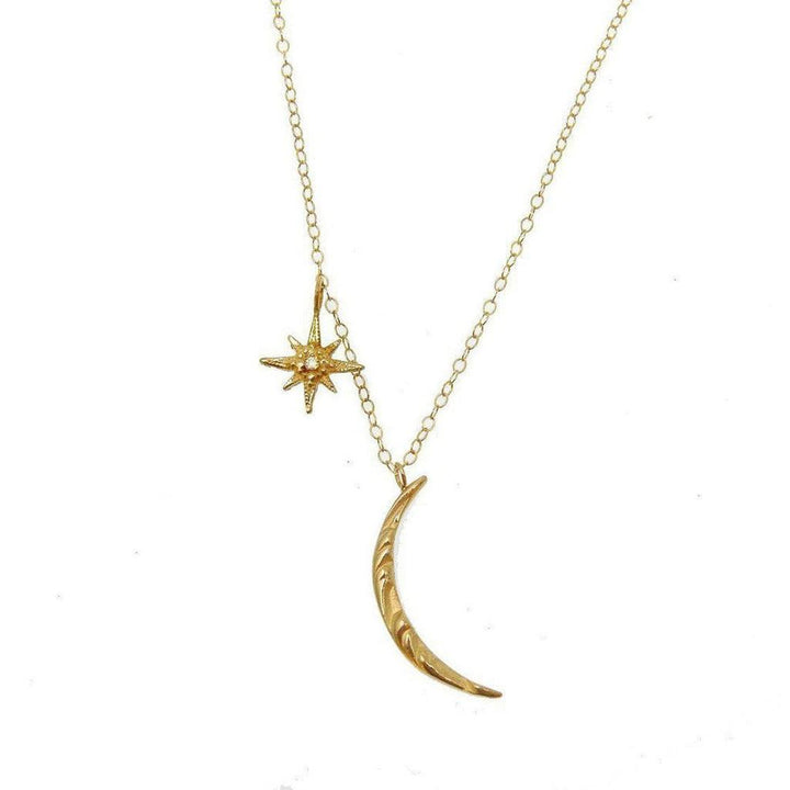 Gold Moon and Tiny Star necklace with textured crescent moon and starburst charm.
