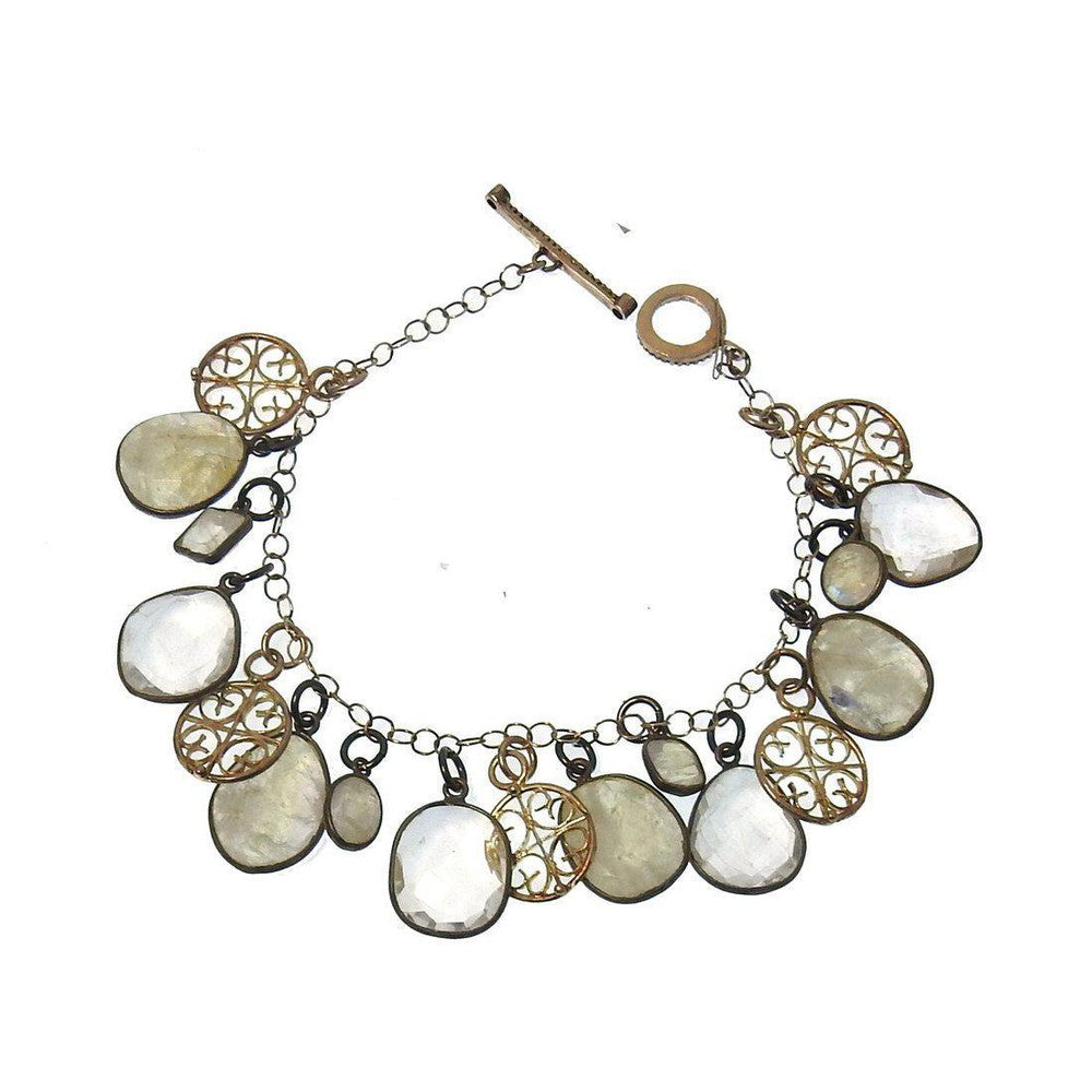 Elegant Moonstone charm bracelet with gold and silver accents.
