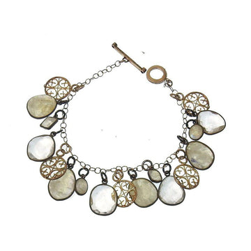 Elegant Moonstone charm bracelet with gold and silver accents.

