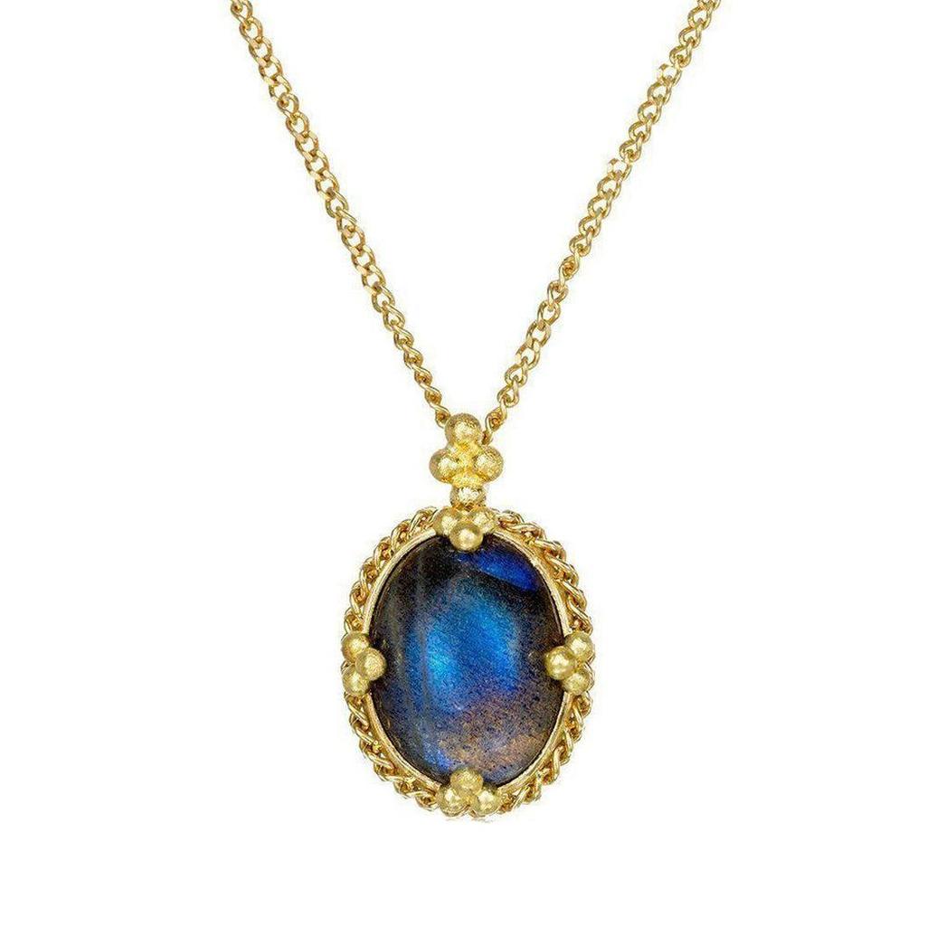 Oval moonstone pendant necklace with gold chain and ornate setting.
