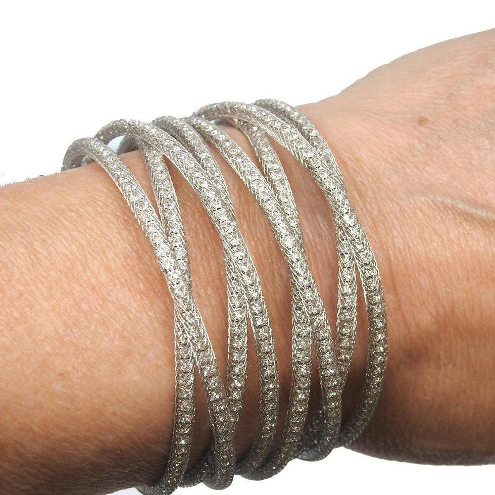 Silver crystal cuff bracelet, multi-row design, worn on wrist.
