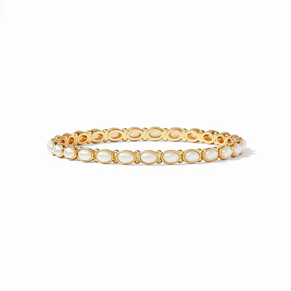 Gold bangle bracelet adorned with oval-shaped white pearls.
