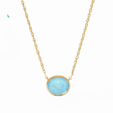 Gold chain necklace featuring a light blue oval gemstone pendant.
