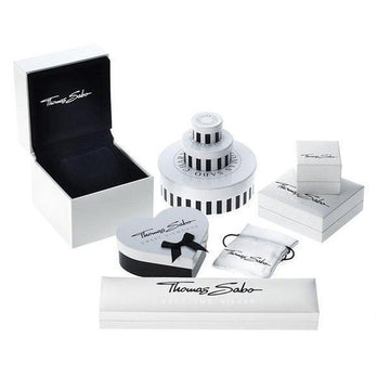Elegant jewelry packaging, showcasing various boxes and a pouch.
