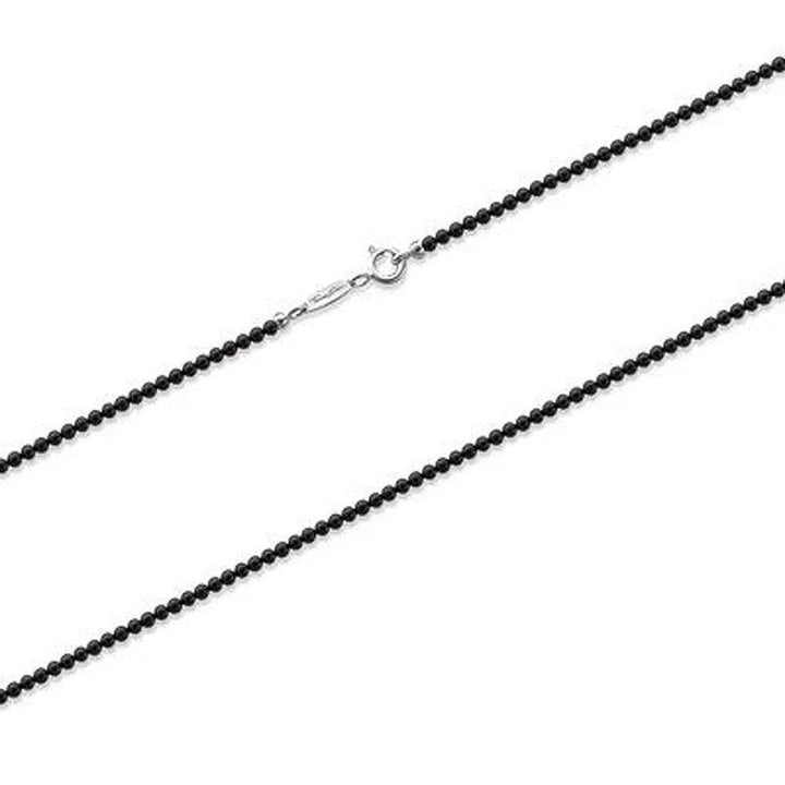 Black beaded necklace with silver clasp, elegant minimalist jewelry.
