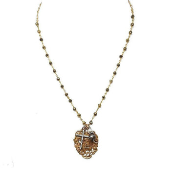 Gold beaded chain necklace with ornate pendant featuring a cross and pearl accents.
