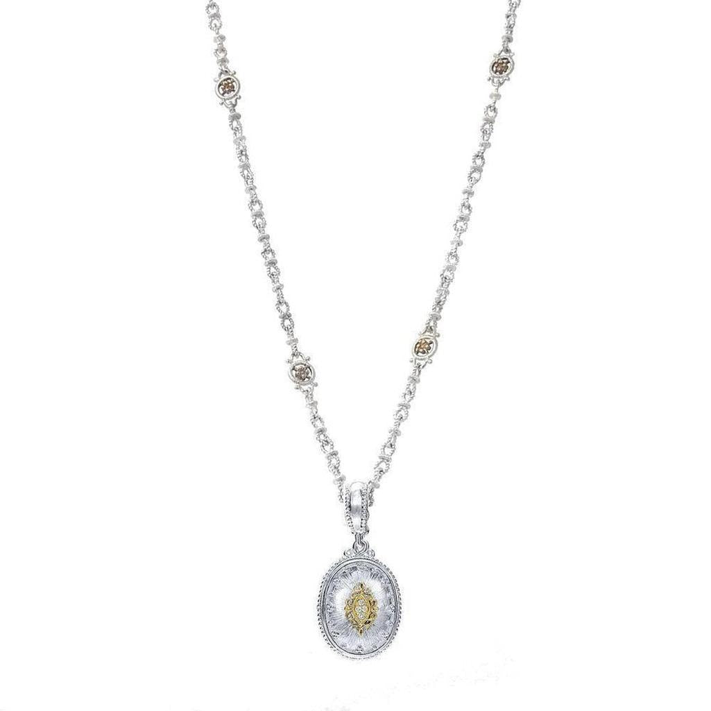 Oval diamond pendant necklace with ornate silver chain and accents.
