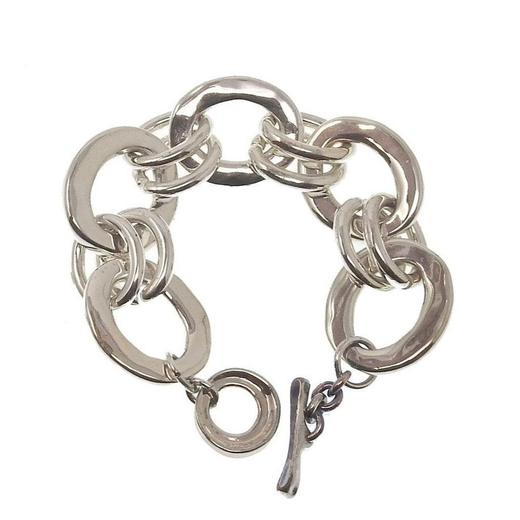 Silver oval chain link bracelet with a toggle clasp.
