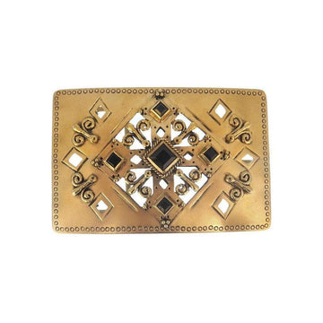 Gold rectangular belt buckle with ornate detailing and dark stones.
