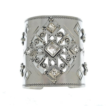 Silver cuff bracelet with ornate cutout design and clear cubic zirconia accents.
