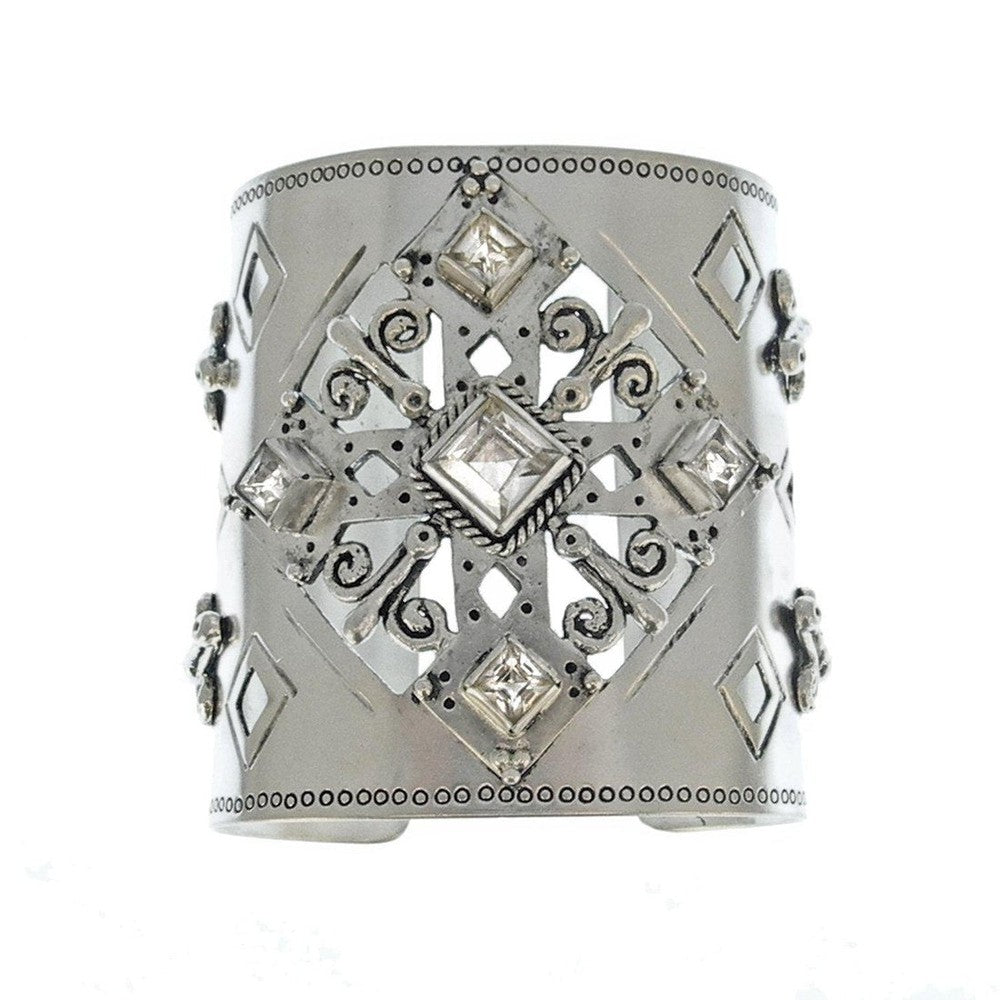 Silver cuff bracelet with ornate cutout design and clear cubic zirconia accents.
