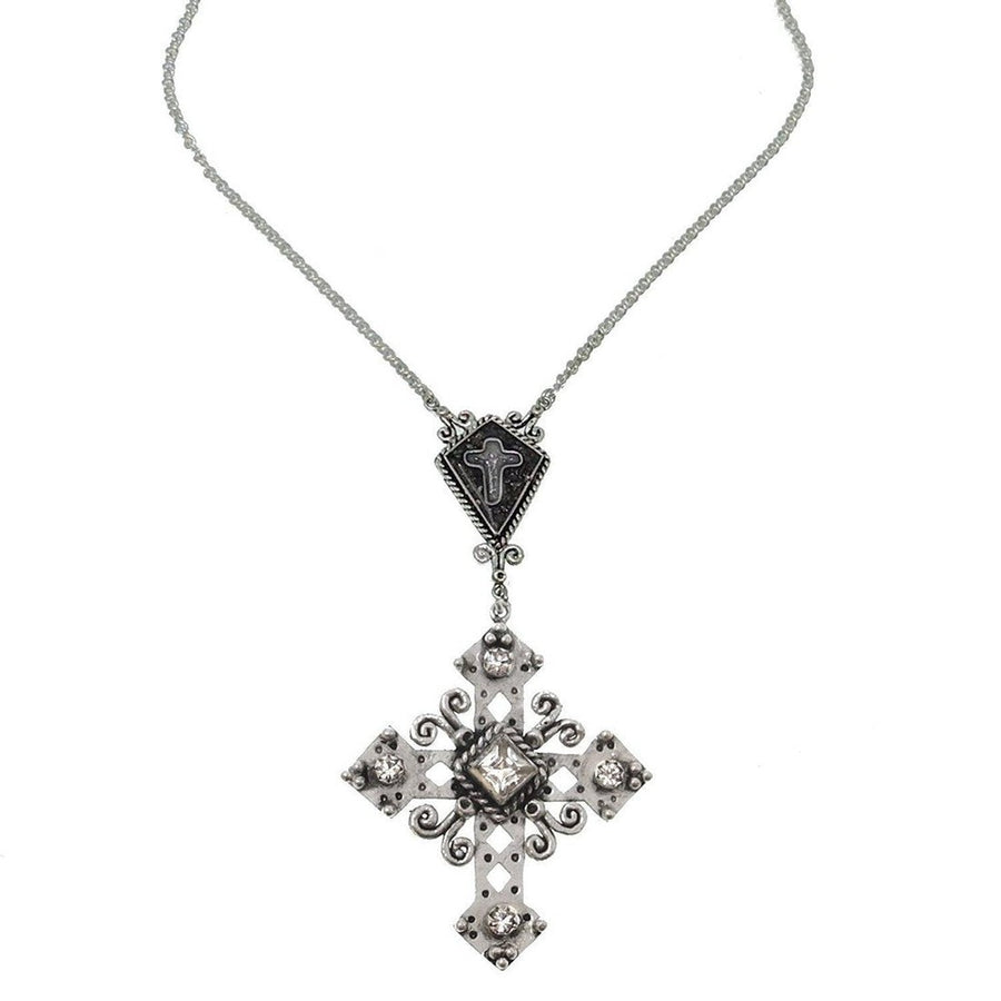 Paloma Cross Necklace in silver, featuring a detailed cross pendant with clear crystals and a smaller cross charm.
