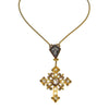 Gold Paloma cross necklace with clear stones and dark cross detail.
